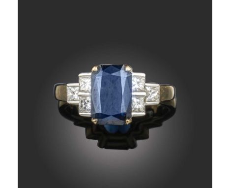 A sapphire and diamond ring, the cushion-shaped sapphire set within princess-cut diamond shoulders in yellow gold, stamped 75