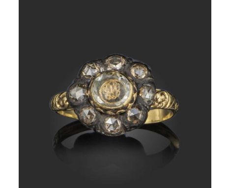 A Stuart crystal and diamond cluster ring, circa 1700, centring on a faceted rock crystal above gold wirework cipher within a