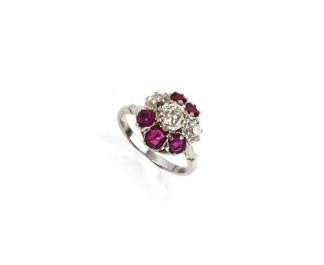 A ruby and diamond cluster ring, set with three graduated old cushion-shaped diamonds and five graduated rubies in white gold