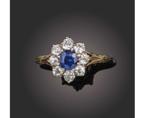 A late 19th century sapphire and diamond cluster ring, set with a cushion-shaped sapphire within a surround of old-cut diamon