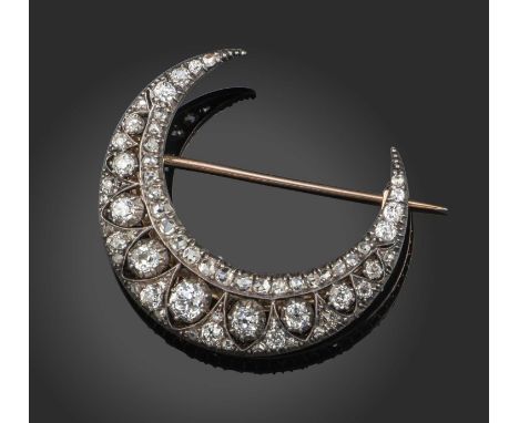 A late 19th century diamond crescent brooch, the design of crescents set with graduated cushion-shaped diamonds in silver and