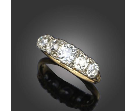 A late 19th century diamond five stone ring, set with graduated old cushion-shaped diamonds and diamond pointers in carved an