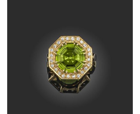 A paste and diamond cluster ring, of octagonal form, centring on a green paste within a surround of circular-cut diamonds in 