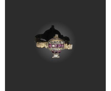 A late 18th century ruby and diamond memorial ring, set with a central stylised urn decorated with rubies and diamonds in sil