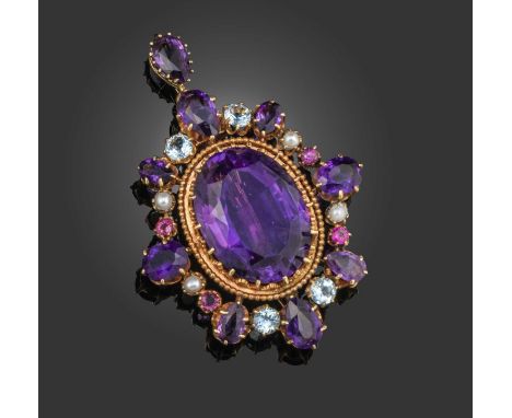 A mid 19th century amethyst pendant, set with a central oval-shaped amethyst claw-set within a surround of graduated amethyst