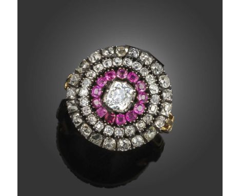 An early 19th century ruby and diamond target ring, set with a central cushion-shaped diamond within a surround of rubies and