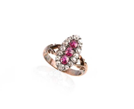 A late 19th century ruby and diamond cluster ring, of eliptical design, set with three rubies in a diamond surround in yellow