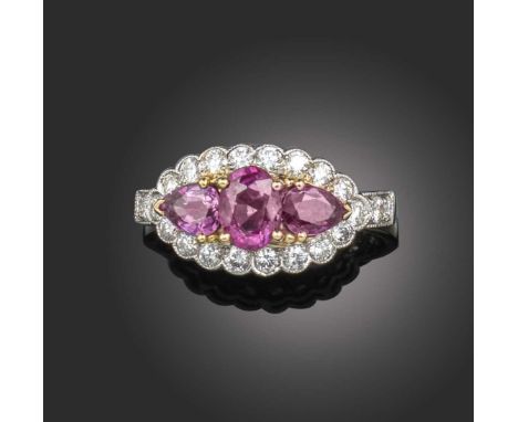 A ruby and diamond half hoop ring, set with an oval ruby flanked with pear-shaped rubies within a surround of diamonds milleg