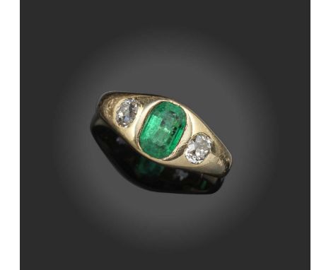 A late Victorian emerald and diamond ring, circa 1900, rubover-set with a step-cut emerald between two old cushion-cut diamon