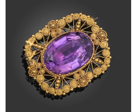 A Regency amethyst-set gold brooch, the oval amethyst within cannetille surround in closed back yellow gold setting, later br