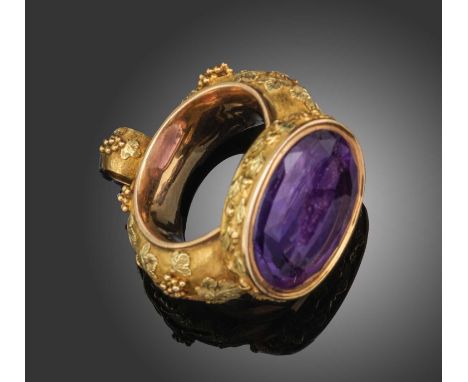 An elaborate Regency gold and amethyst seal, circa 1820, of stirrup form and finely decorated with fruiting vines in three co