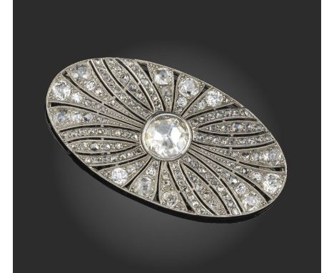 An early 20th century diamond brooch, centring on a rose-cut diamond within pierced and radiating surround millegrain-set wit