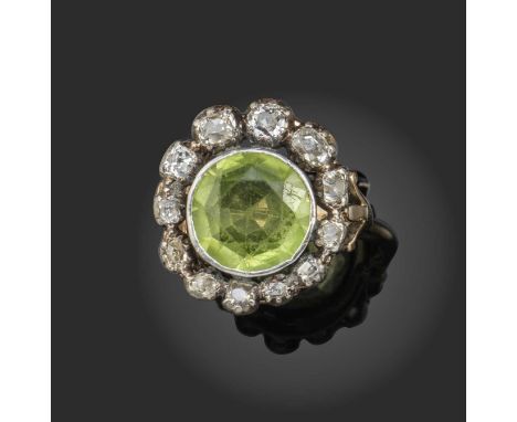 A peridot and diamond cluster ring, 19th century and later, the circular-cut peridot surrounded by graduated old cushion-cut 