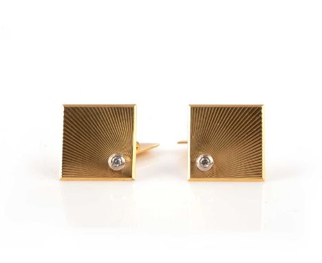 A pair of diamond cufflinks, each with a square terminal decorated with a radiating motif set with a round brilliant-cut diam