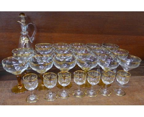 A set of seven liqueur glasses, a decanter with gilded decoration and seventeen champagne coupes, (eleven with coloured stem)