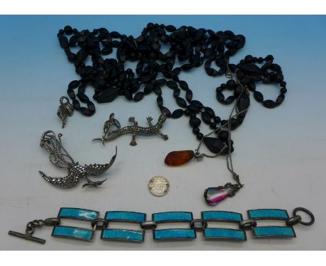 An .800 silver and enamel bracelet, two silver and marcasite brooches, bird and lizard, two pendants with chains, a pair of s
