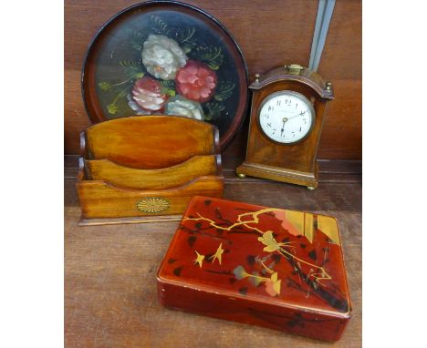 A 19th Century mahogany cased mantel clock, Thos Smith & Sons with later battery movement, an Edwardian mahogany letter rack,