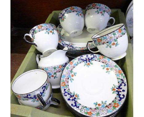 A Delphine china tea service; six cups, ten saucers, ten medium plates, two cake plates and cream