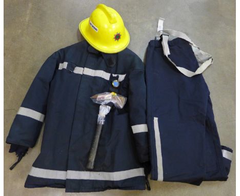 A fire brigade helmet, 1990, jacket, trousers, axe and torch