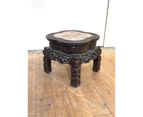 A Chinese rosewood jardiniere stand, late 19th century, the lobed circular top with inset rouge marble panel, profusely carve