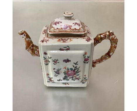 A Chinese Export porcelain teapot, of oblong form, each side with raised panel, decorated in a famille rose palette with flor