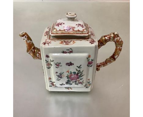 A Chinese Export porcelain teapot, of oblong form, each side with raised panel, decorated in a famille rose palette with flor