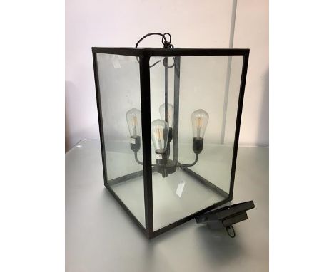 A contemporary black metal-framed four-light hanging lantern, of oblong form, with stepped square ceiling rose. Lantern 57cm 