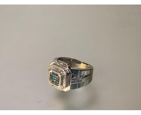 A gem-set cluster ring, the central square plaque pave-set with blue zircons, within a band of small baguette-cut diamonds, o