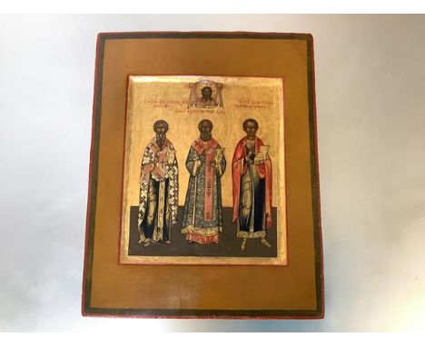 Russian School, 19th Century, an icon depicting three saints, against a gold ground, oil on panel. 22cm by 17.5cm. Provenance