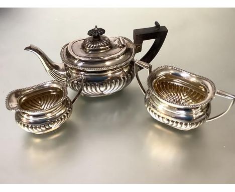 A late Victorian silver three piece bachelor's tea service, Thomas Hayes, Birmingham 1897, in the Georgian taste, each piece 