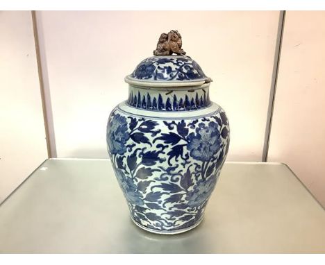 A large Chinese blue and white porcelain jar and cover, 19th century, of baluster form, the domed cover applied with an ungla