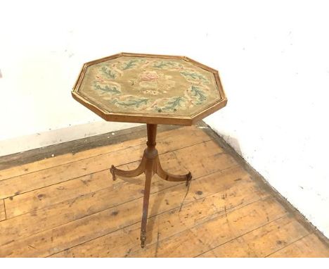 A George III oak tripod table (alterations), the shaped octagonal top inset with a petit point panel worked in coloured wools