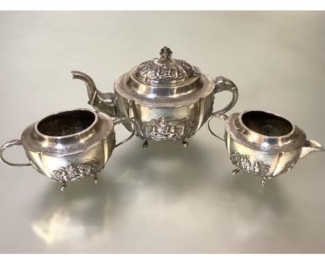 An Indian white metal three piece tea service, c. 1900, each piece of oval form, the teapot with elephant head handle and spo