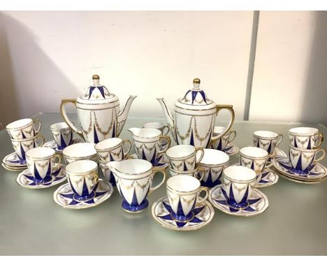 A Spode double coffee service, 1930's, pattern no. Y7940, decorated with powdered blue and gilt triangles joined by floral sw