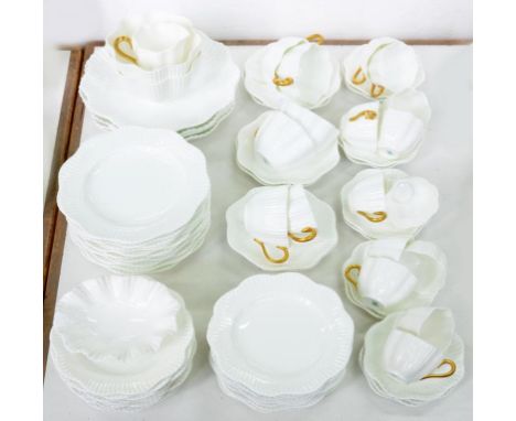 A COALPORT SHELL FLUTED GLAZED PORCELAIN AND GILT HANDLED TEA SERVICE, LARGER PLATE 25CM D, PRINTED MARK, C1900 ++Mostly in g