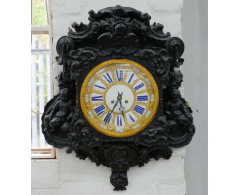 A PROFUSELY AND EBONISED NAPOLEON III WALL CLOCK, THE GILT BRASS DIAL WITH BLUE ENAMEL CHAPTERS, INSCRIBED LE ROY A PAIRS, IN