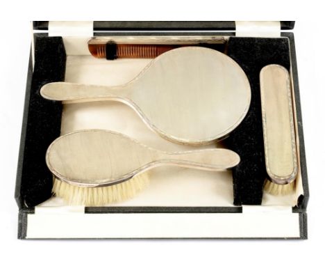 AN ELIZABETH II FOUR PIECE SILVER BRUSH SET, ENGINE TURNED, APPARENTLY UNUSED, BIRMINGHAM 1965, CASED 