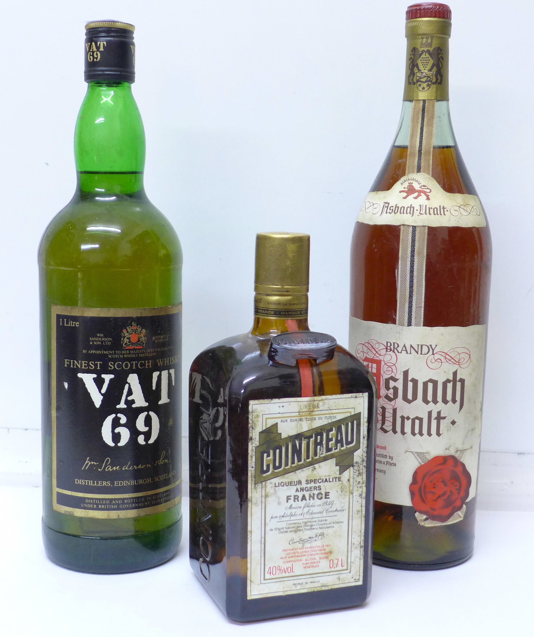 A bottle of VAT 69 whisky, a bottle of Cointreau and a bottle of Asbach