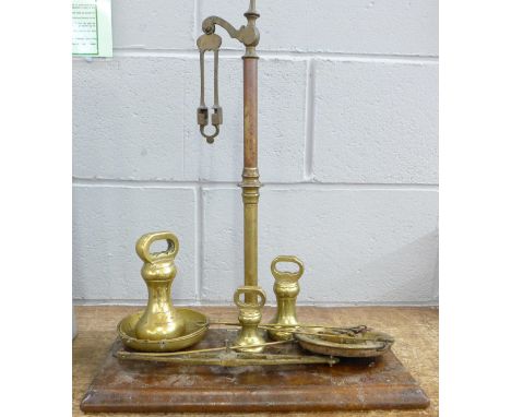 A set of scales and three brass bell weights