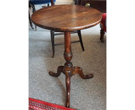 A 19th Century Mahogany Tripod Table, the circular top raised on turned column and tripod base, 63cm high, 37cm wide
