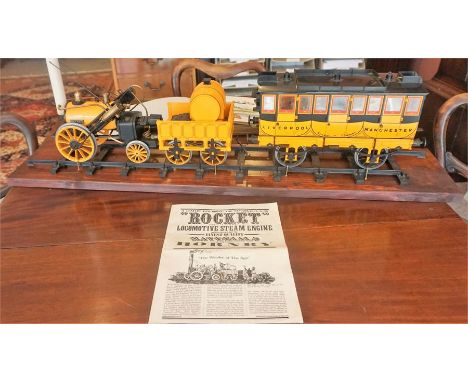 A Hornby "Rocket" Model Of A Locomotive Steam Engine, 30cm high, 85cm wide, raised on wooden plinth, with instruction booklet