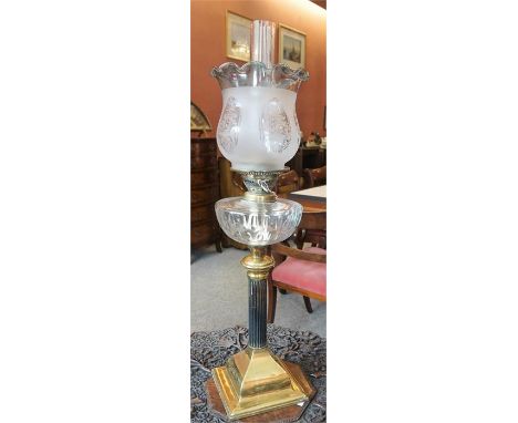 A Late Victorian Brass Corinthian Style Oil Lamp by Eatex, with clear glass reservoir, green tinted frilly glass shade and fu