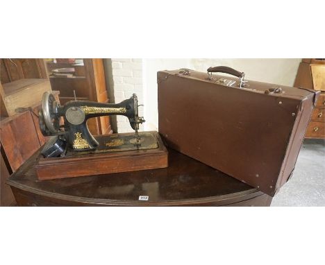 A Vintage Singer Table Sewing Machine, also with a vintage suitcase, (2)