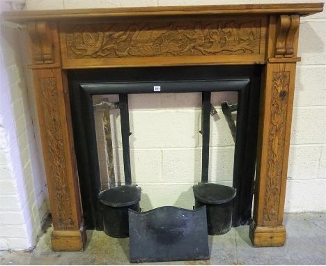 A Carved Wood Fireplace, with painted cast iron insert, to include grate and canopy, (insert 82 x 72.5cm, overall 121cm high,