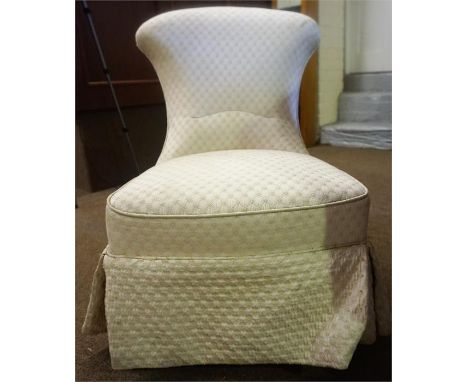 A Victorian Mahogany Nursing Chair, upholstered in later white fabric, raised on turned reeded legs with ceramic castors, 73c