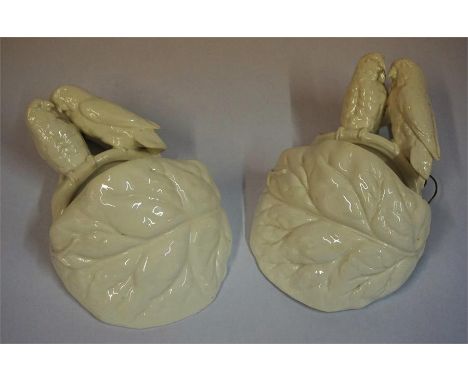A Pair Of Victorian Wall Pockets By Royal Worcester, with a surmount decorated with parrots perched on a naturalistic branch,