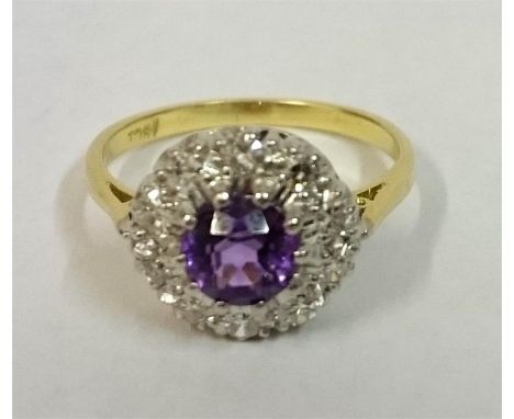 A Ladies 18ct Gold Dress Ring, set with a centre Amethyst surrounded by small Diamonds, ring size O