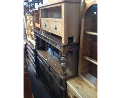 Three pieces of furniture; a carved oak court cupboard, a modern light oak TV stand and a pine folding step chair. 