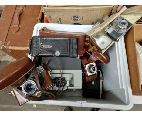 A box containing cine projector, 2 cameras and various tape reels 