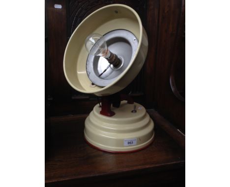 A vintage adjustable angle lamp on stepped metal base, converted from a heat lamp. 
